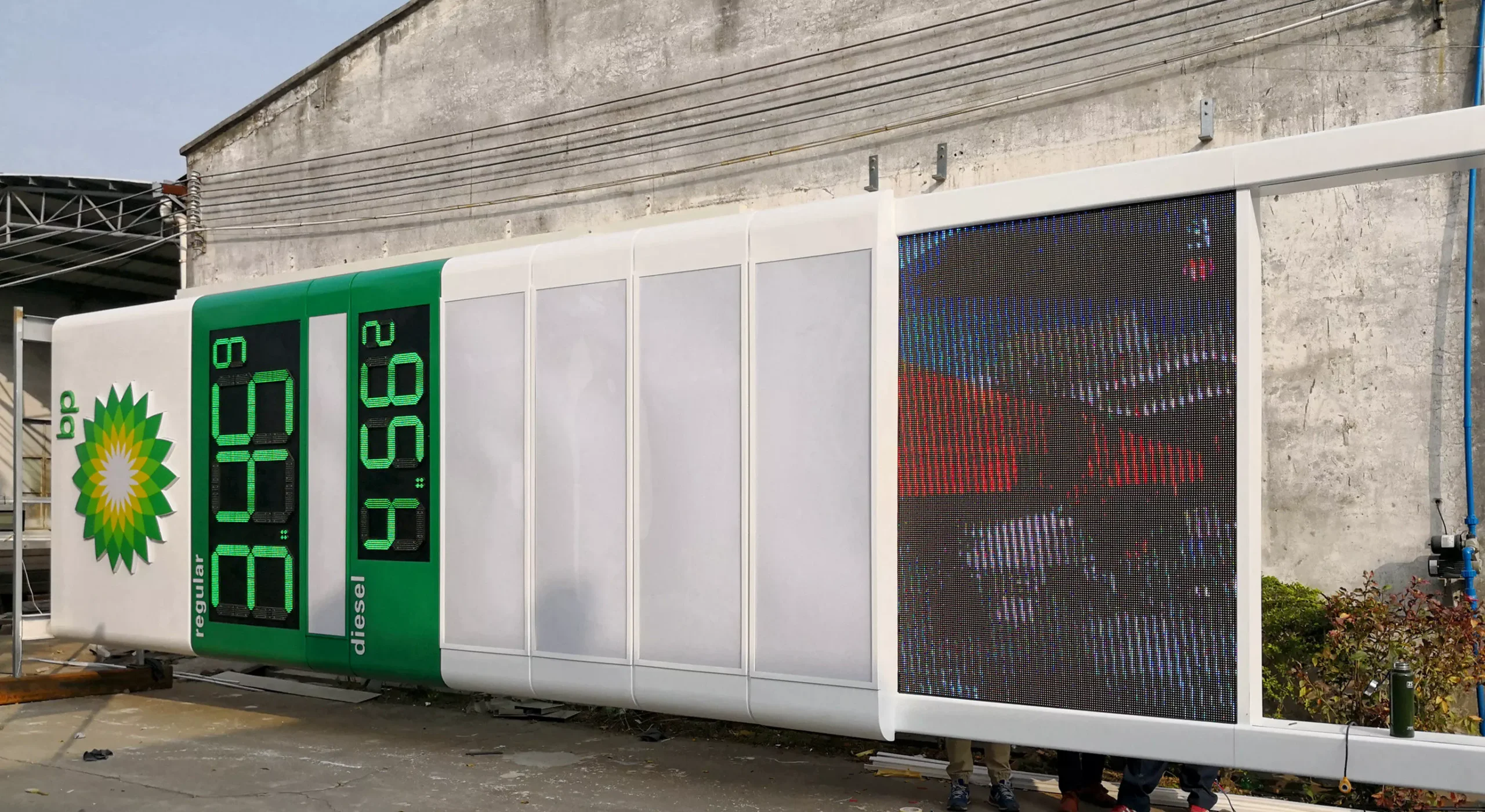 Large outdoor LED video wall integrated into LED gas station sign structure
