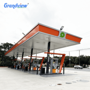 Custom steel space frame gas station canopy roof structure with orange fascia design by Grandview Factory