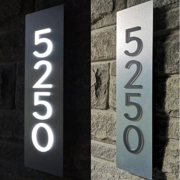 Custom backlit LED house number factory product showing illuminated 5250 vertical address sign on stone wall