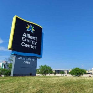 Custom wayfinding pylon sign factory project for Alliant Energy Center with blue and yellow branding
