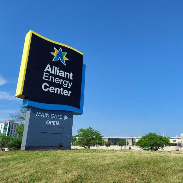 Custom wayfinding pylon sign factory project for Alliant Energy Center with blue and yellow branding