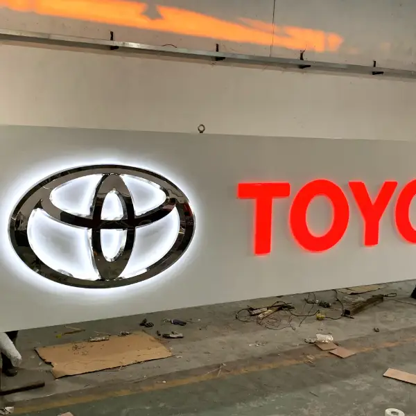 Automotive commercial signage manufacturing featuring outdoor pylons and chrome logos