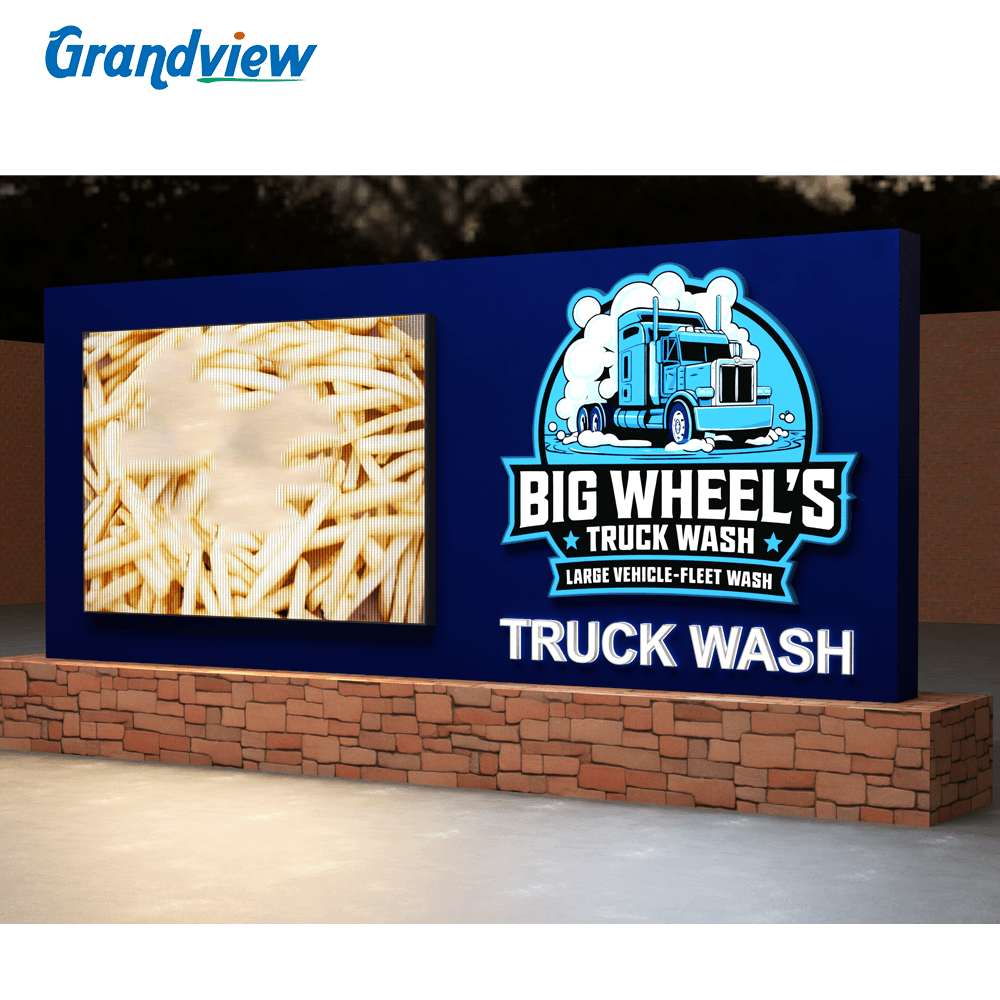 Custom monument sign factory project showing outdoor illuminated sign for Big Wheel's Truck Wash on brick base
