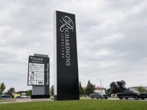 Modern black industrial pylon sign design for corporate business centers